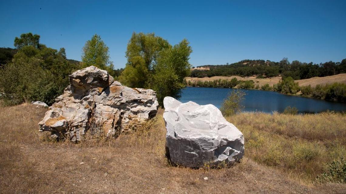 Boulders border a lagoon on a former limestone quarry in El Dorado County, in 2013. Marble Valley Co. wants county zoning changes to build 3,235 homes and town houses on the site south of Highway 50.