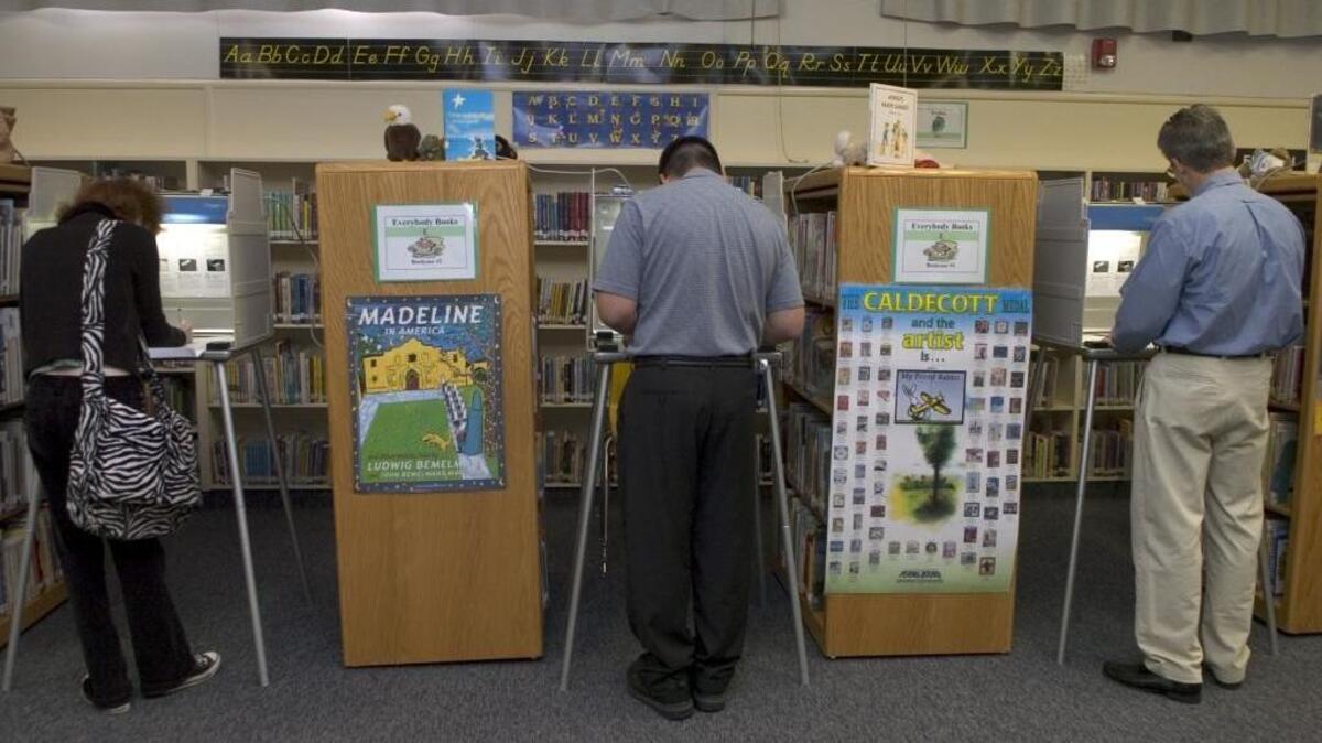 Voters make their choices on their ballot inside the library at Phoebe Hearst Elementary School on Tuesday, November 7, 2006.