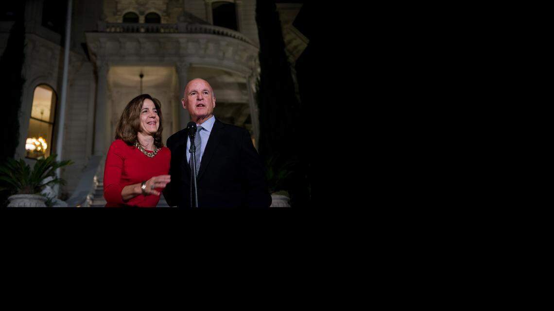Gov. Jerry Brown and first lady Anne Gust Brown stand outside the Historic Governor's Mansion on Tuesday night. Brown easily won re-election to his fourth term as governor, 40 years after securing his first term.