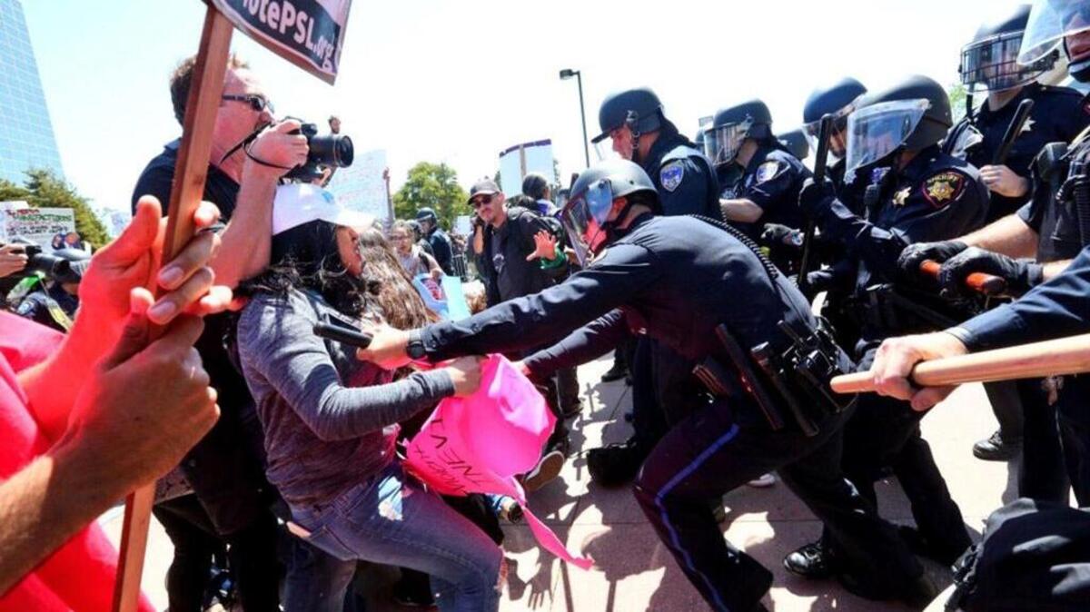 Protesters break through the barricade, rush for the entrance and clash with police outside the California Republican Convention on April 29, 2016 in Burlingame, Calif.