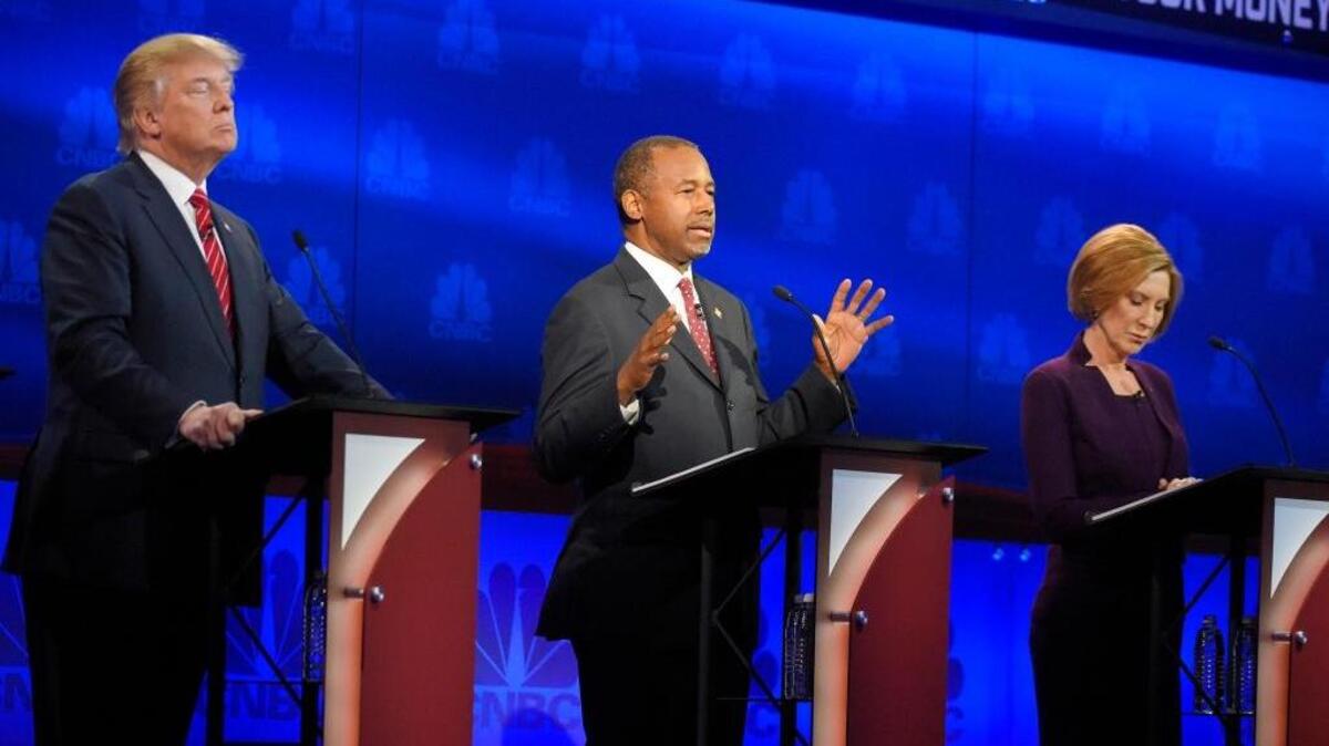 Ben Carson, center, makes a point as Donald Trump, left, and Carly Fiorina look on during the CNBC Republican presidential debate at the University of Colorado, Wednesday, Oct. 28, 2015, in Boulder, Colo.