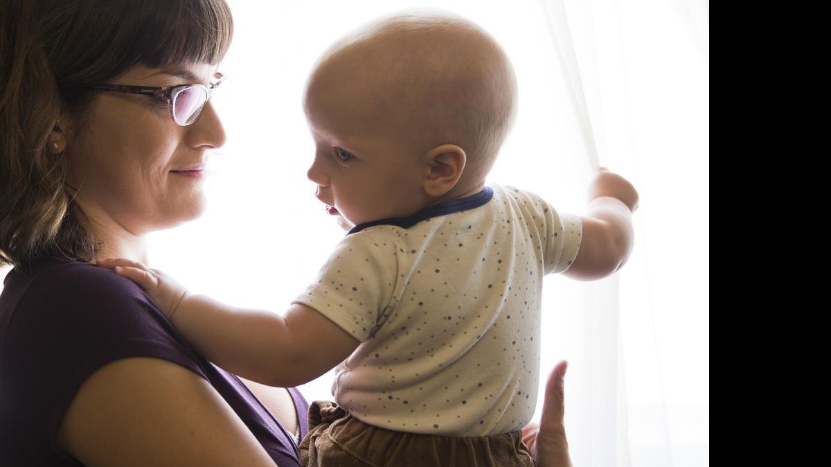 
 At her Pasadena home, Ariel Loop, 27, holds her 7-month-old son Mobius, who contracted measles in January at Disneyland. Mobius is fully vaccinated, but the measles, mumps and rubella vaccine isn’t given until the age of 1. 

