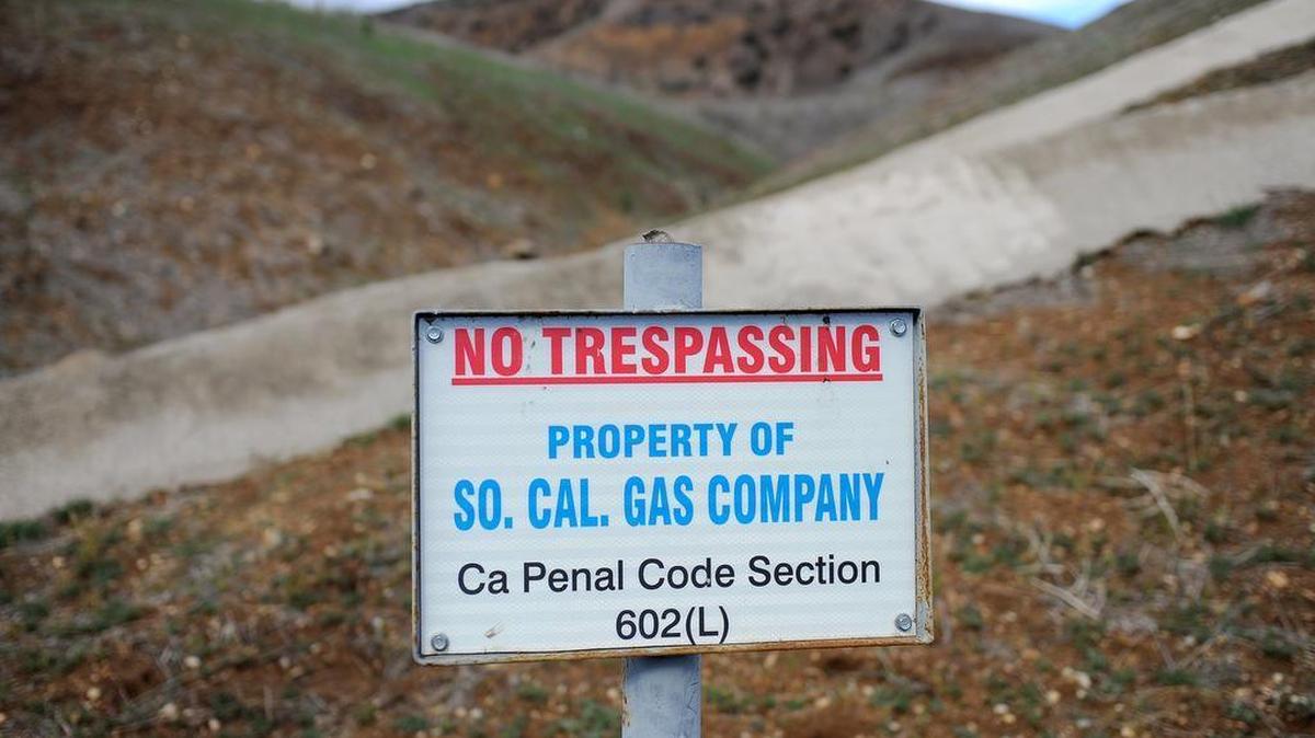 In this Jan. 7, 2016, file photo, a sign declares the boundary line of the Southern California Gas Co. gas fields where a gas well was leaking methane daily near the community of Porter Ranch in Los Angeles.