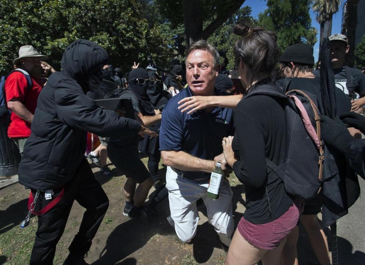 KCRA television reporter Mike Luery runs away from members of the group called ANTIFA Sacramento (Anti-Fascism Action), who were staging a counter-protest against the Traditionalist Worker Party and the Golden State Skinheads, at the state Capitol on June 26.