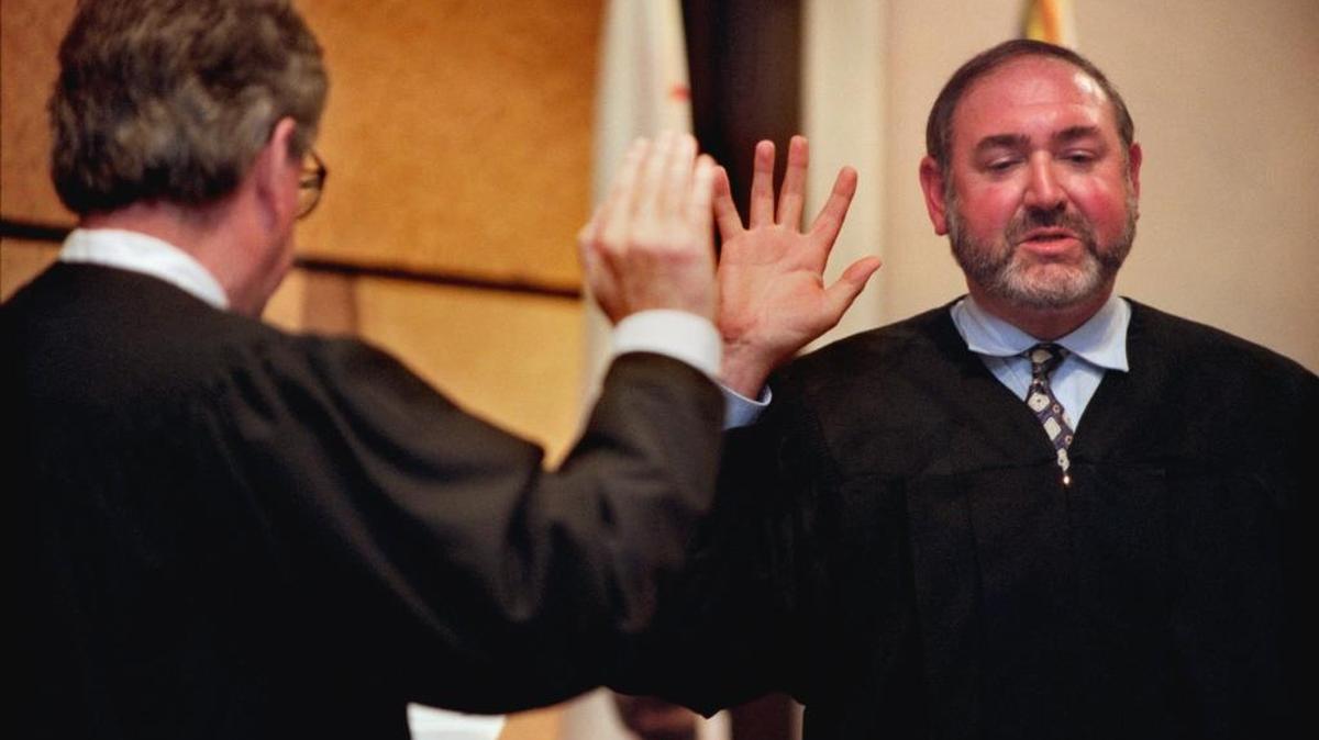Loren McMaster, right, takes the oath to become a Sacramento Superior Court judge in 1999.