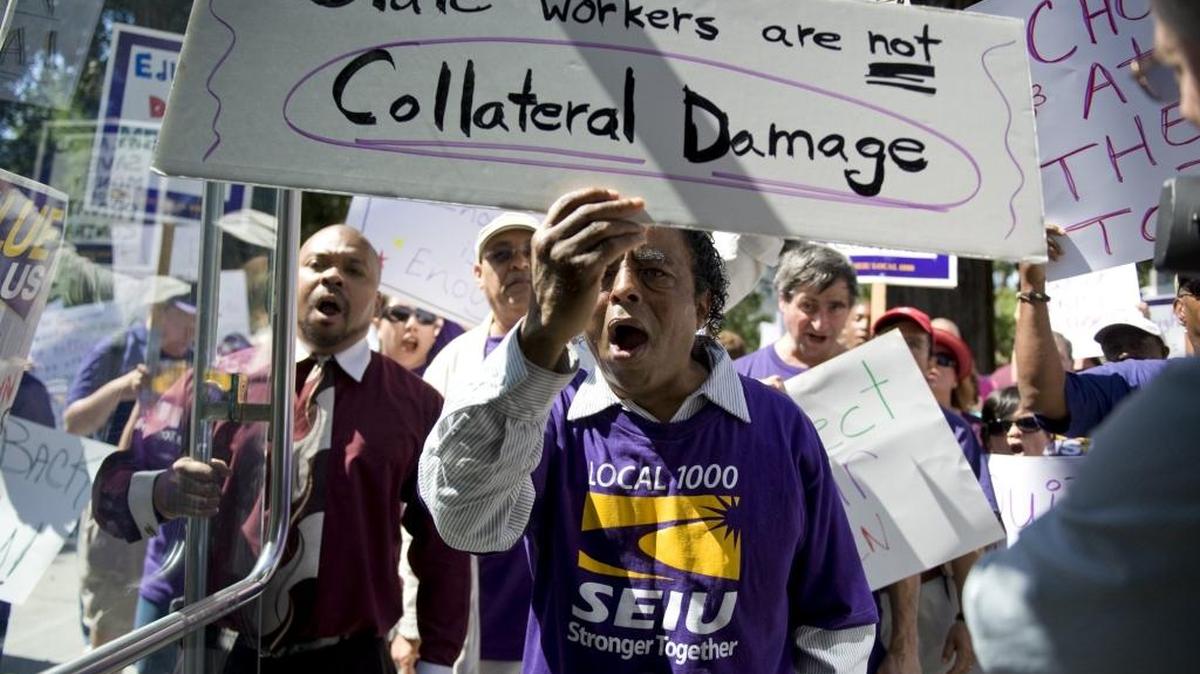 Dennis Maxey, center, a Transbay Terminal worker from Oakland, joins Members of SEIU Local 1000, representing 95,000 state employees as they rallied at the Capitol on Wednesday, July, 1, 2009.