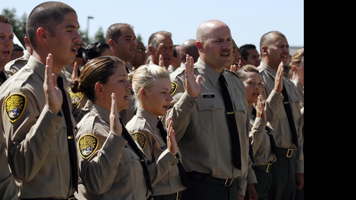 
Cadets take the oath of office during their swearing in as correctional officers at the Department of Corrections and Rehabilitation academy in Galt.
