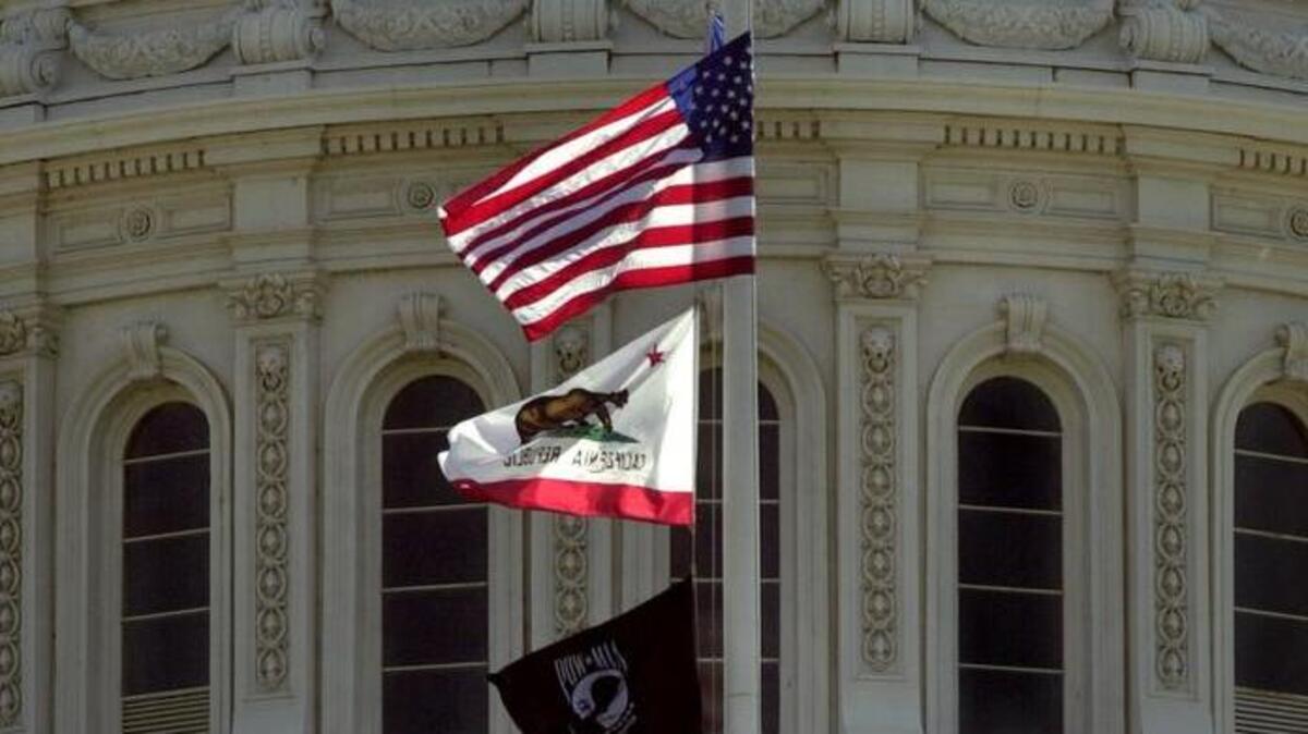 Flags fly at half staff in front of the rotunda of the California Capitol in 2001.