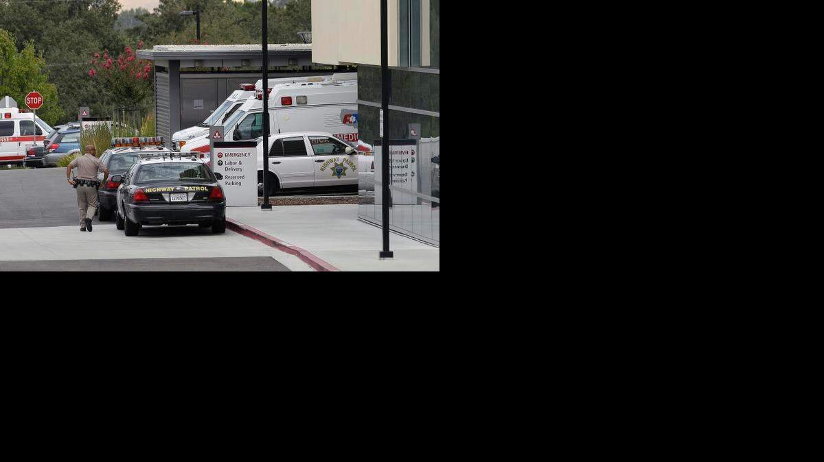 
A California Highway Patrol officer walks toward John Muir Medical Center in Walnut Creek, Calif.
