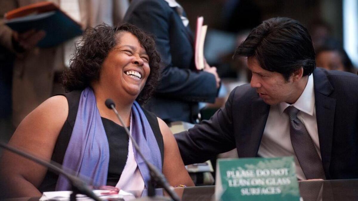 Yvonne Walker, president SEIU Local 1000, talks with Senator Kevin de León, D-Los Angeles, at the State Capitol in 2012.