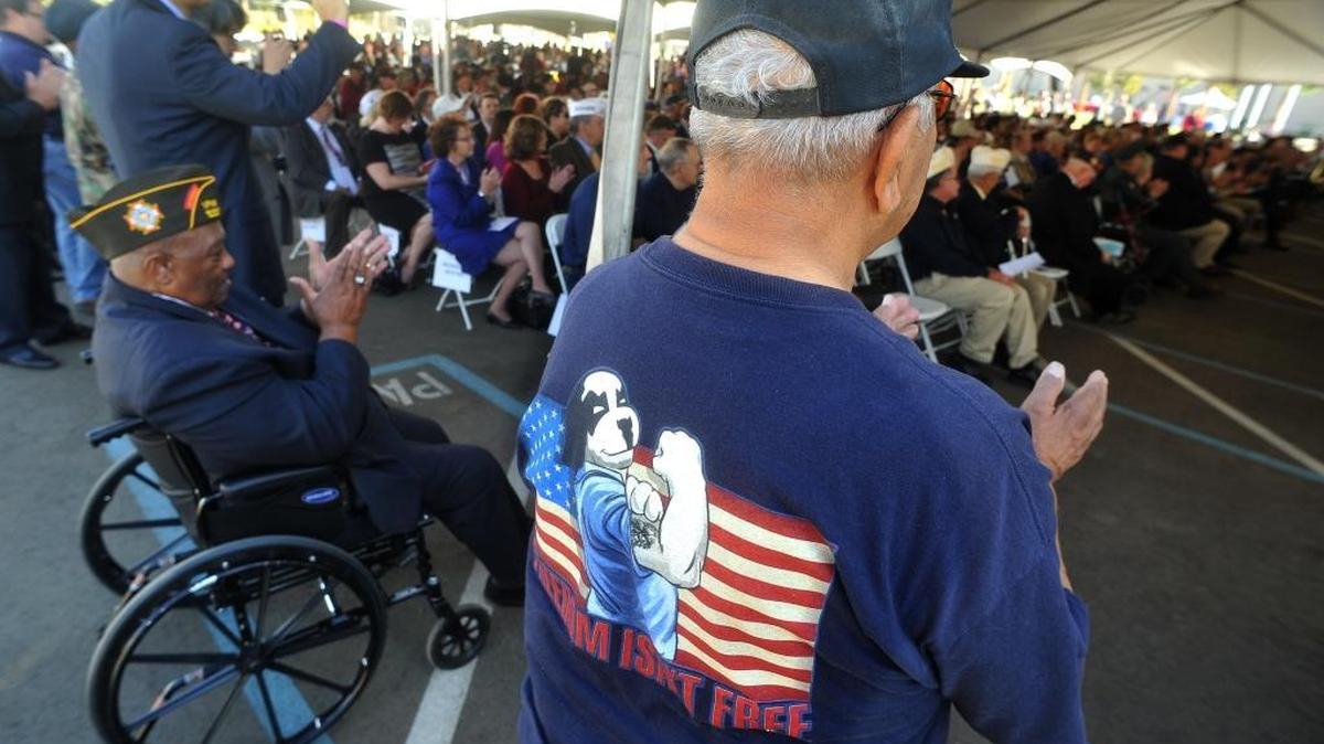 Veterans applaud a speaker during the grand opening ceremonies for the new Veterans Home of California in Fresno on Oct. 18, 2013.