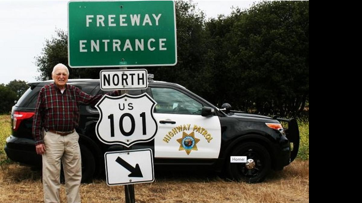 
CHP volunteer Homer Bosserman, who turns 101 on Saturday, stands next to an appropriate highway sign.
