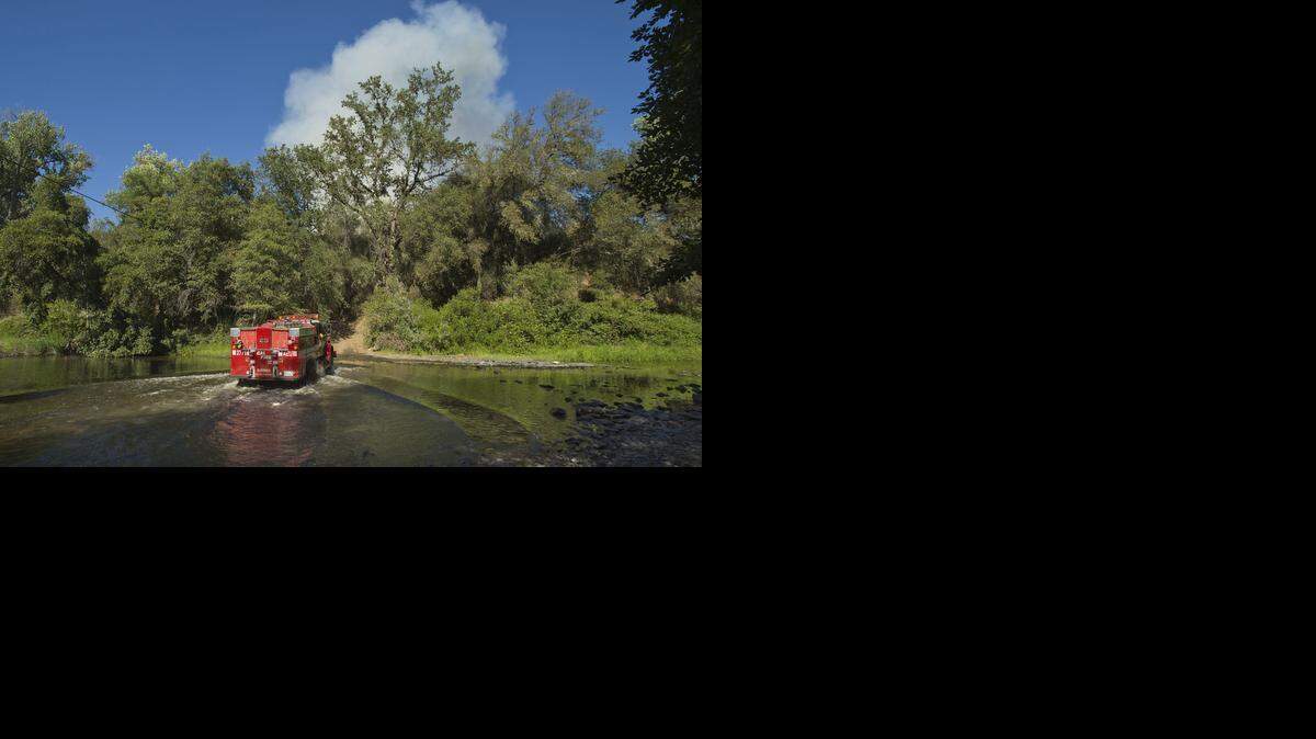 
A Cal Fire truck fords a stream as a wildland fire burns near Plymouth last year. The department faces allegations of boozing and sexual misconduct. 
