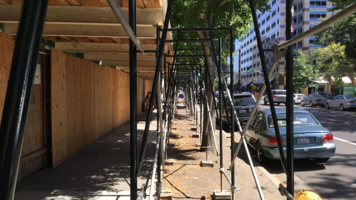 
A section of the plywood-and-metal scaffolding protecting pedestrians on the 5th Street side of the Board of Equalization building in Sacramento.
