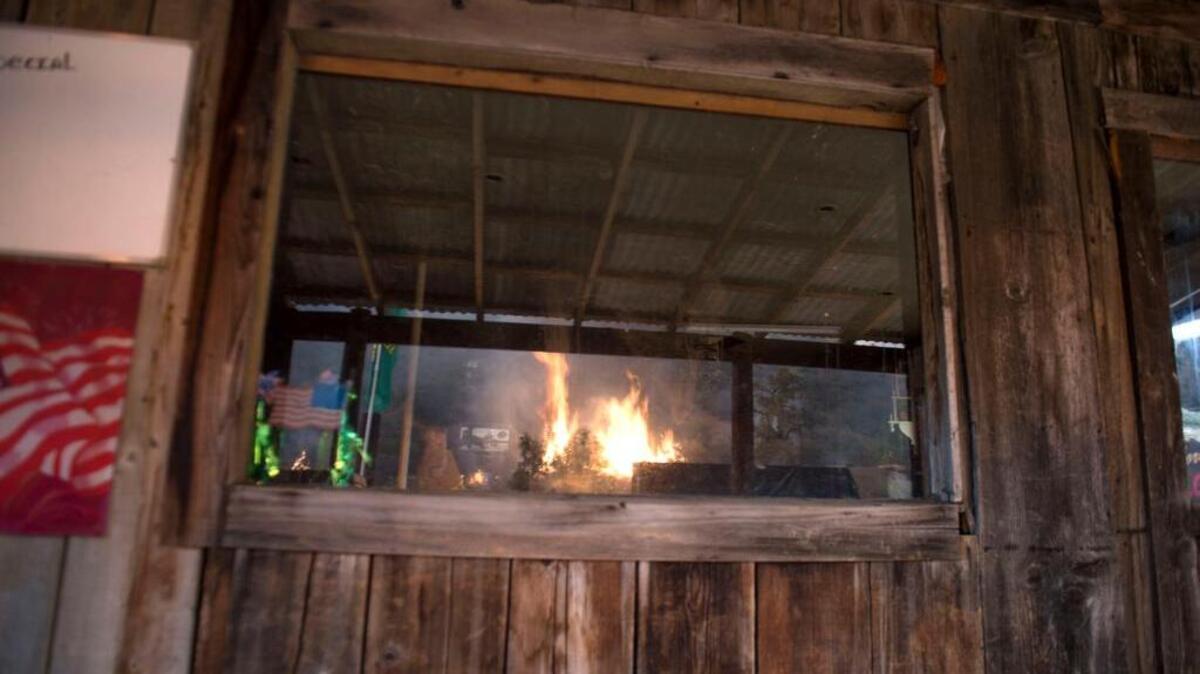 
A back fire burns as seen thru a window at The Oasis bar in Lake County on Sunday, August 2, 2015.
