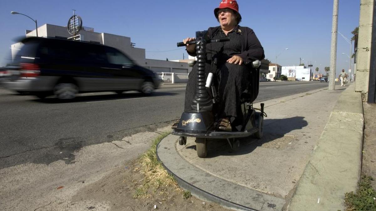 In this 2006 file photo, Stephanie Bussi of Californians for Disability Rights is stopped by a curb drop-off on the Pacific Coast Highway in Long Beach. Law enforcement officials announced bribery charges Wednesday against Caltrans’ state coordinator for the Americans with Disabilities Act.