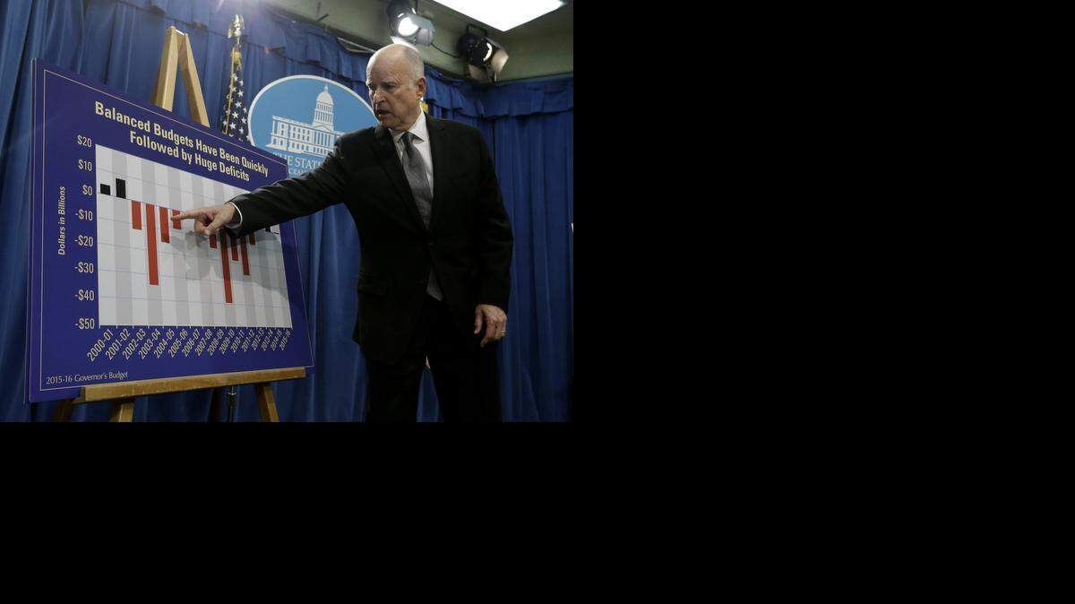 
Gov. Jerry Brown uses a chart to show how budget deficits often follow budget surplus years as he discusses his proposed $113 billion 2015-16 state budget plan at the Capitol in Sacramento. 

