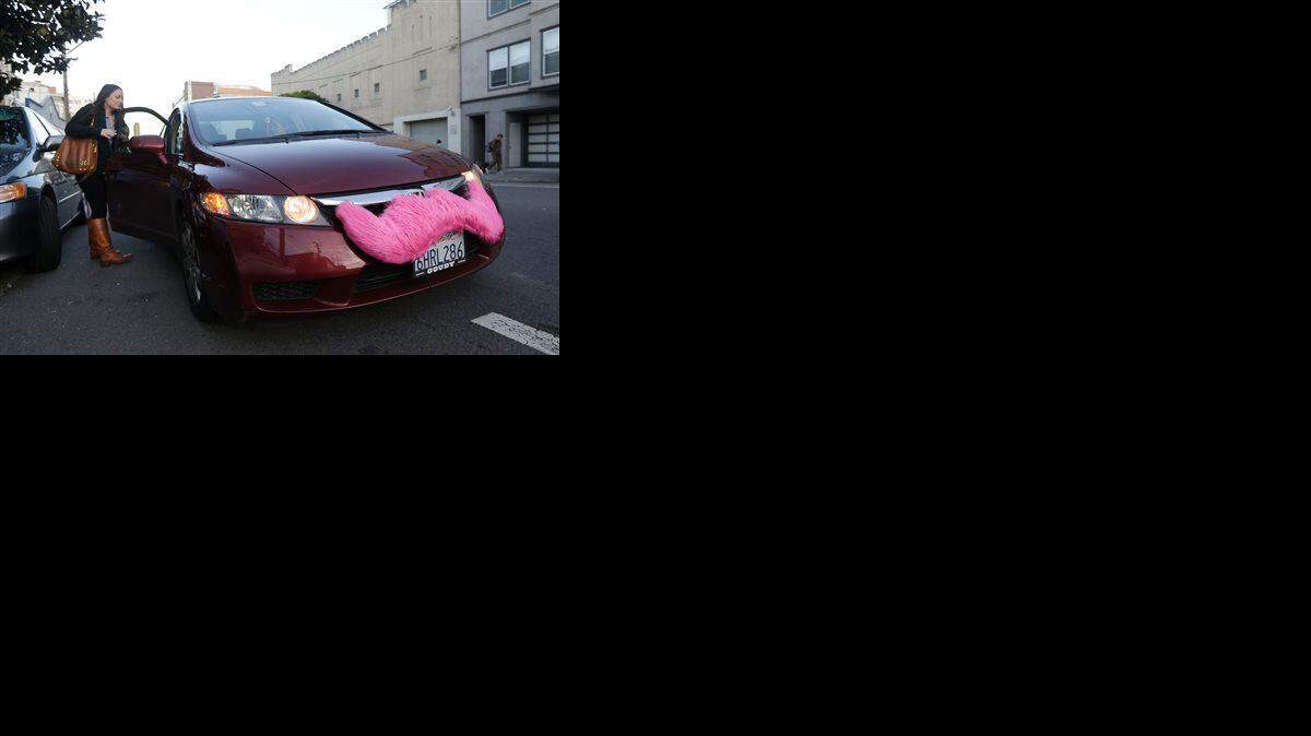 
Lyft passenger Christina Shatzen gets into a car driven by Nancy Tcheou in San Francisco.
