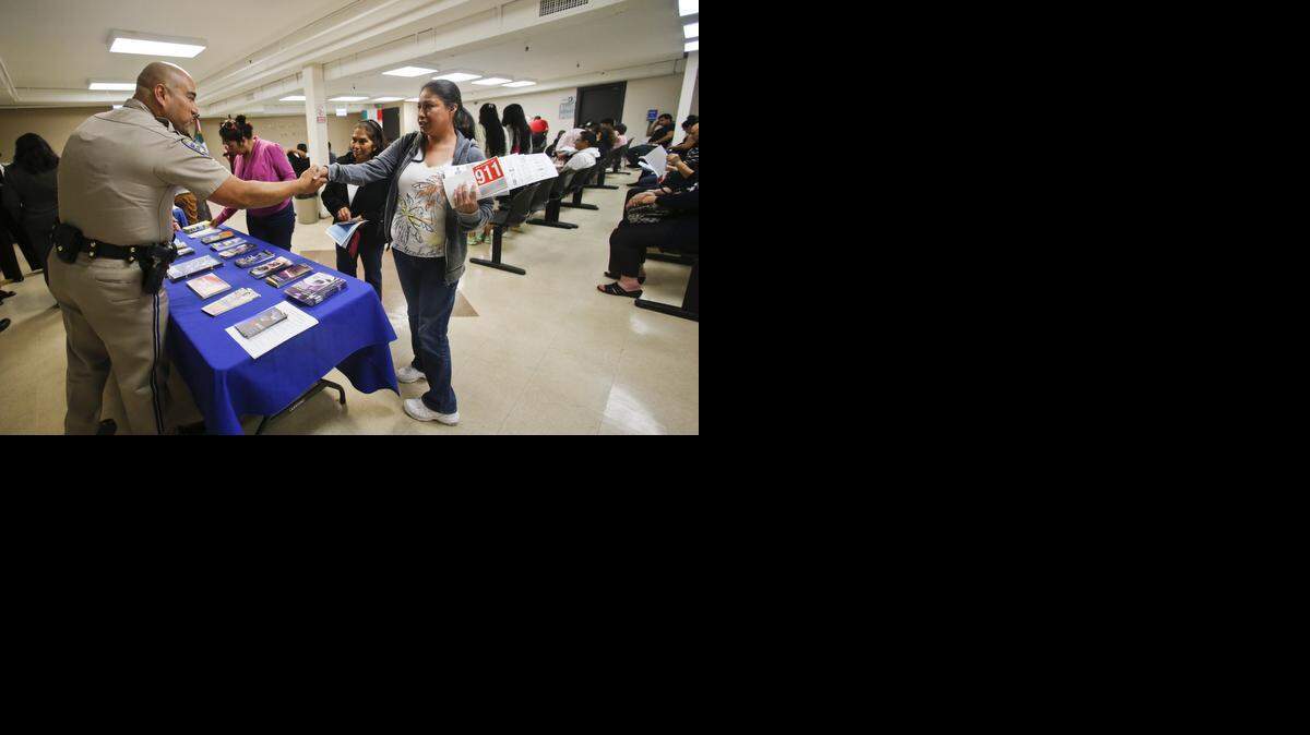 
California Highway Patrol officer Armando Garcia greets several women who were part of approximately 80 adults attending a information session regarding obtaining a California drivers license at the Mexican Consulate in San Diego on Wednesday, April 23, 2014.
