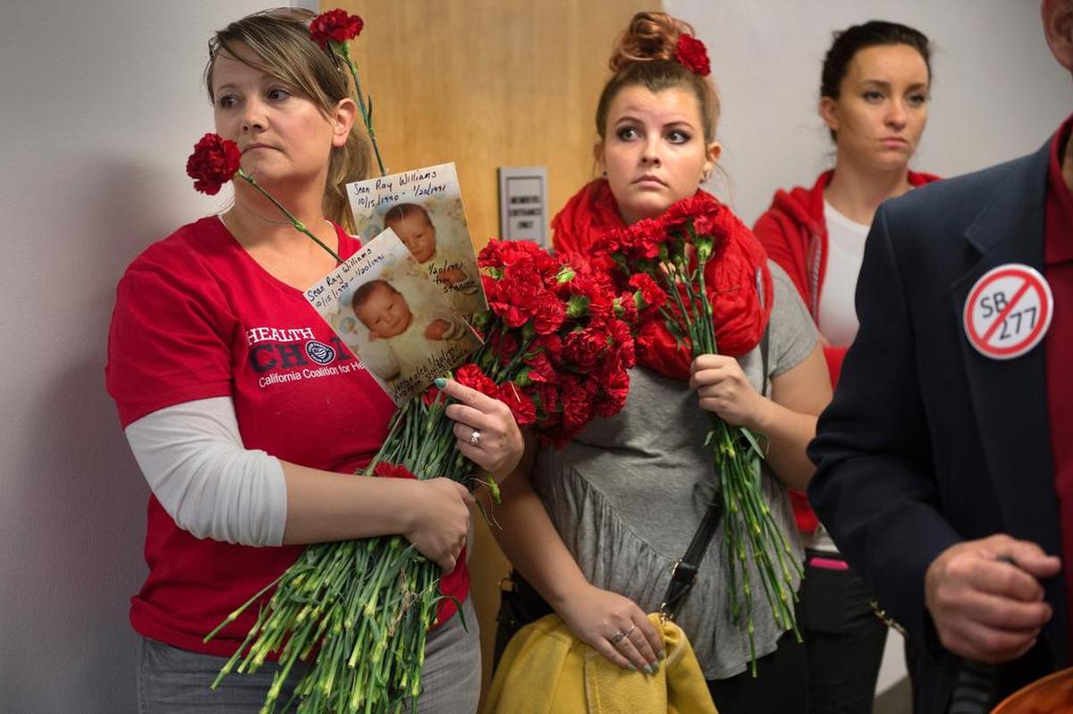 Jennifer Aleksic, left, says her daughter Kiley Michalec, center, had a seizure after a vaccination at age 18 months.