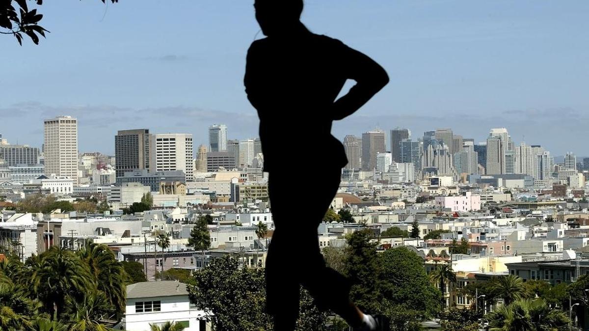 A woman jogs above Dolores Park in San Francisco.