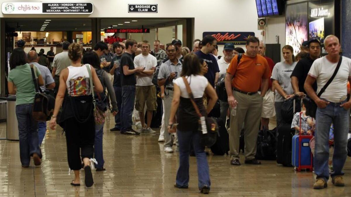 
Travelers wait in a long security line in Terminal B at Sacramento International Airport at the start of Labor Day weekend in August 2007.
