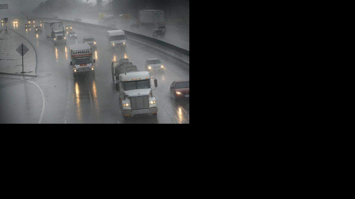 
Traffic travels north on Highway 99 in the rain Dec. 11, 2014. The major storm in December involved an atmospheric river – a phenomenon that top scientists are studying in Sacramento this week.
