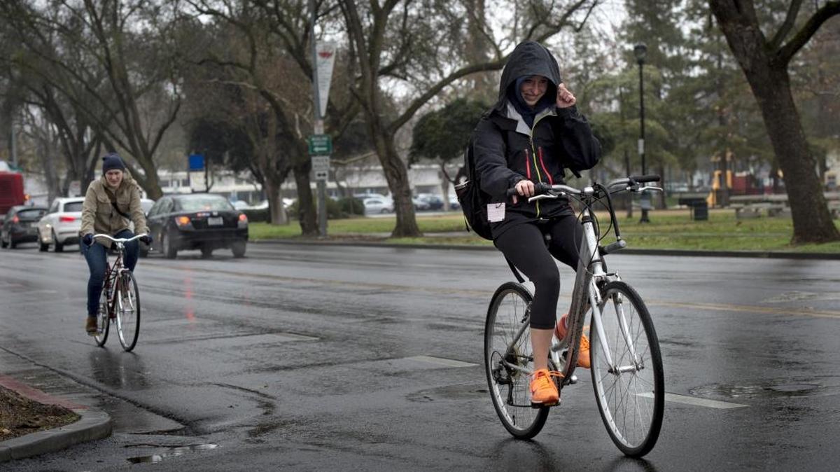 Students bike to class on the campus of UC Davis in the rain as El Nino brings the first weather system of the week to Northern California on Monday, Jan. 4, 2016.