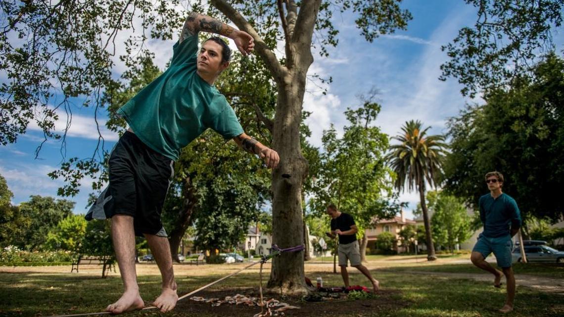 
Topher Ludlow enjoys the cool weather and a break from triple digit heat by slacklining for the first time since injuring his pelvis seven months ago at Mckinley Park on Thursday, July 9, 2015, in Sacramento.
