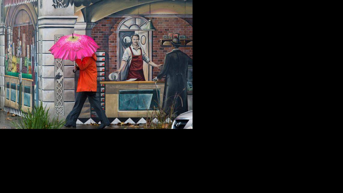 
A pedestrian keeps dry as she turns the corner of Capitol Avenue and 17th Street during a soggy day as a weather front moved through the region, dropping about a half inch of rain in Sacramentoon Tuesday.
