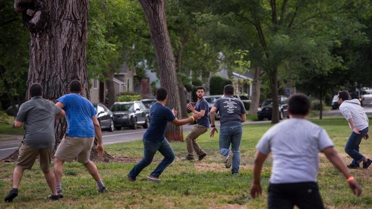 Civil engineering students from Sacramento State play a pre-graduation celebratory flag football game, at Sierra Vista Park in Sacramento on Friday, May 20, 2016. The graduation ceremony is Saturday.