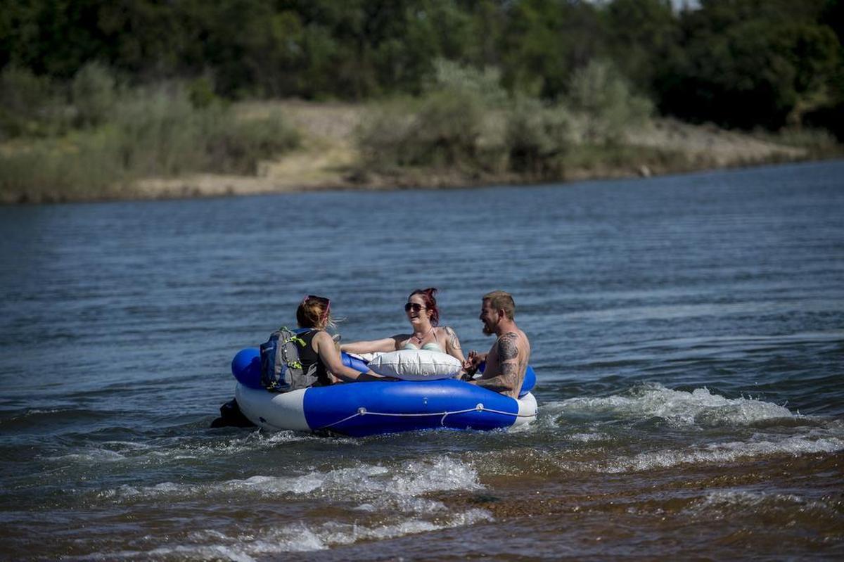 A group enjoying the hot weather float down the American River at the Rossmoor Bar on Wednesday, April 6, 2016, in Rancho Cordova.