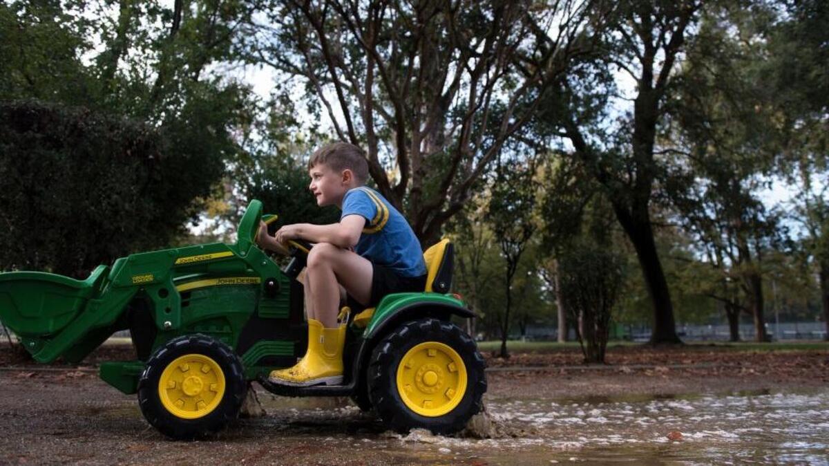 With a face of determination as he plows through a puddle, Colin Kirchner, 6, takes advantage of a break in the rain Sunday, Nov. 8, 2015, while out with his dad on his battery-operated tractor at Sacramento’s McKinley Park.
