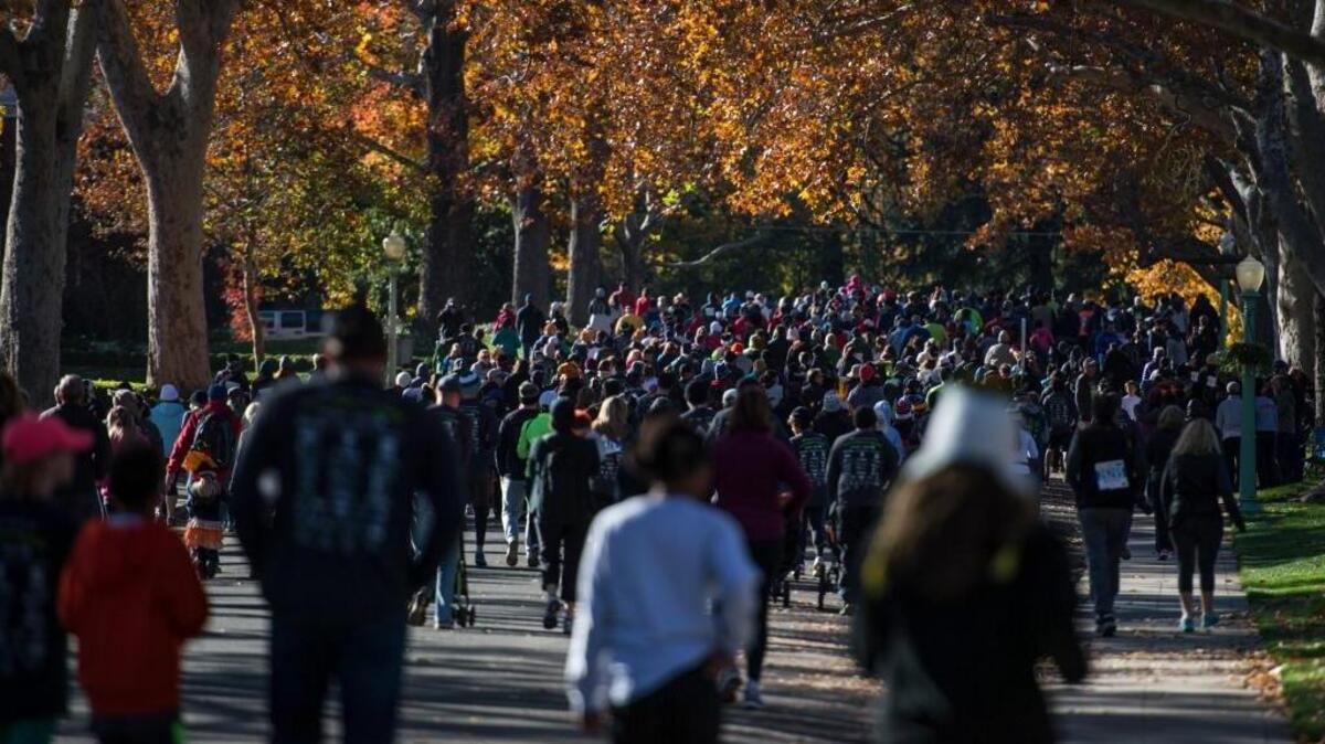 Runners and walkers participate in the 5k walk and run in East Sacramento at the 22nd annual Run to Feed the Hungry on Thursday, Nov. 26, 2015, in Sacramento, Calif.