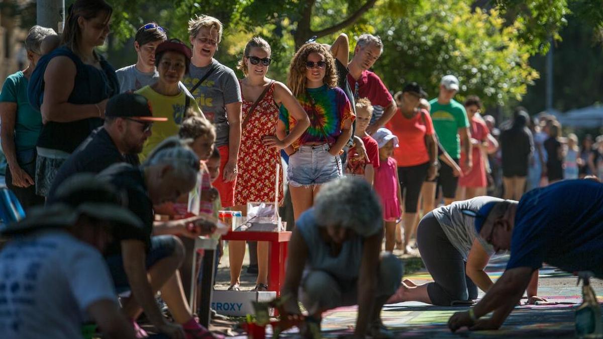 
Onlookers watch as artists work on chalk sidewalk art during the 25th annual Chalk It Up Festival during Labor Day at Fremont Park.
