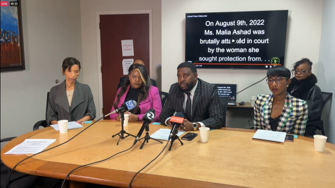 Malia Ashad and her attorneys announce the lawsuit at a Feb. 1 news conference.