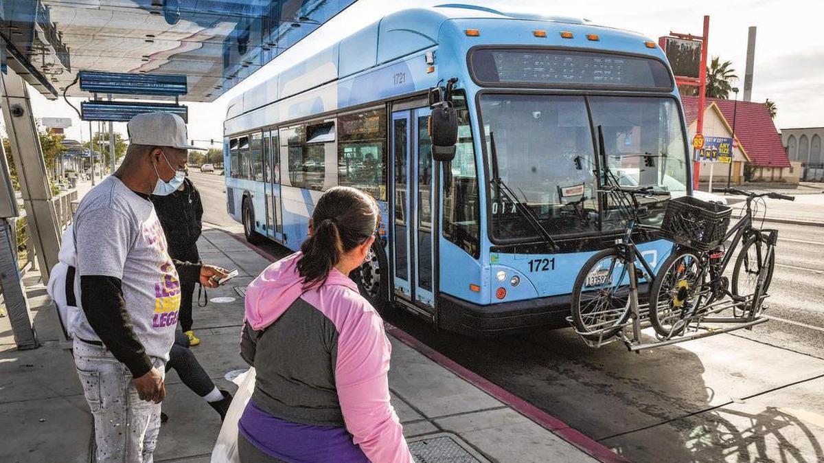 Passengers prepare to board a FAX bus at a stop near Manchester Center.