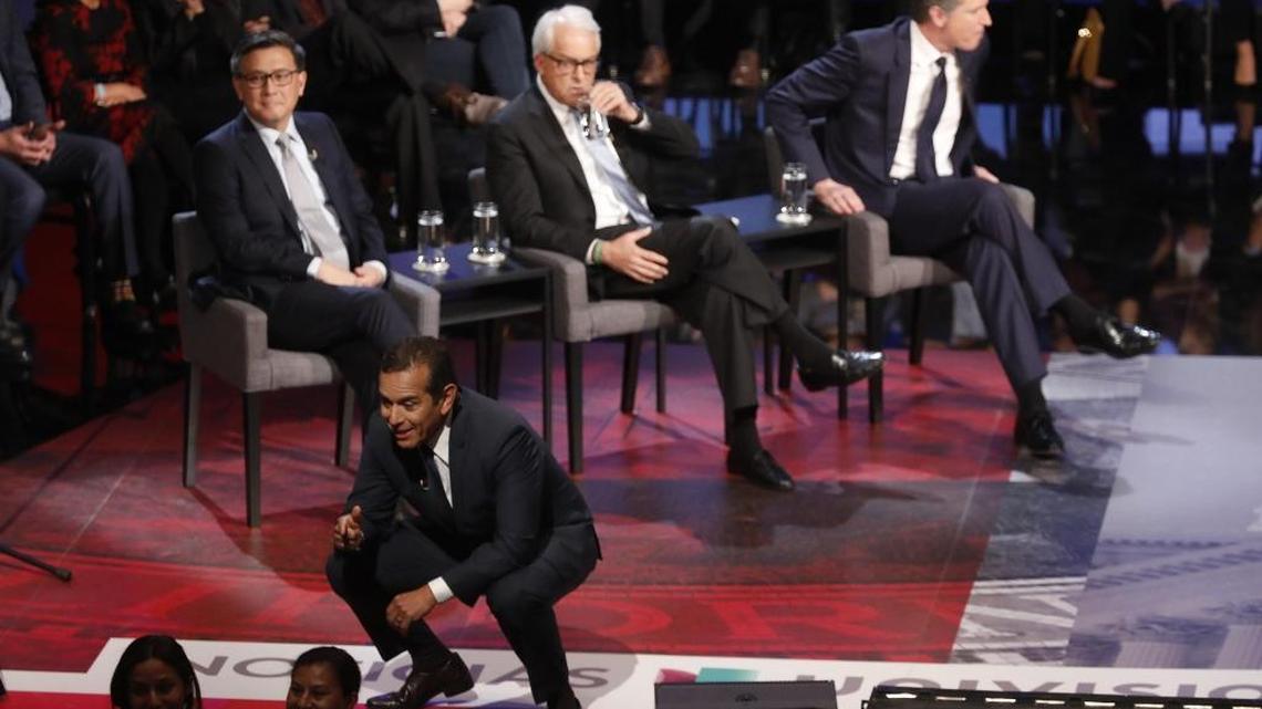 California gubernatorial candidates, from left, State Treasurer John Chiang, John Cox, and Lieutenant Governor Gavin Newsom wait for the debate to begin as former mayor of Los Angeles Antonio Villaraigosa, foreground, talks with supporters at UCLA on January 25, 2018, in Los Angeles. (Genaro Molina/Los Angeles Times/TNS)