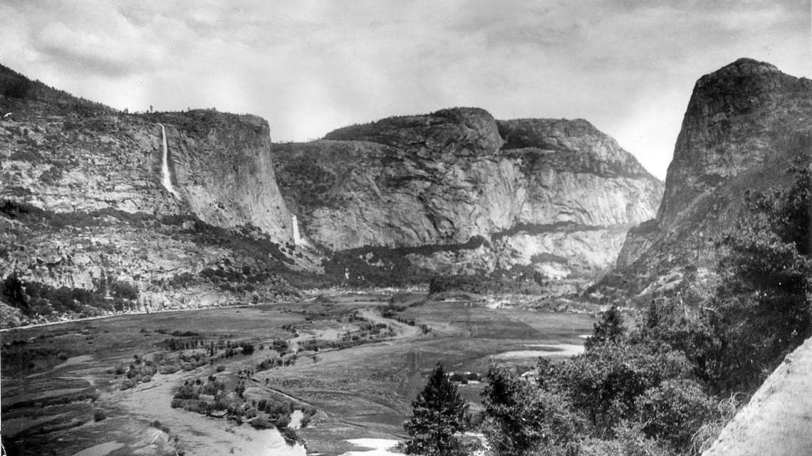The broad valley of the Tuolumne at Hetch Hetchy was a peaceful, green oasis before the O’Shaughnessy Dam was completed in 1923. The river meandered its way westward, fed by the twin Wapama Falls. Hetch Hetchy closely resembled Yosemite Valley before the dam was constructed.
