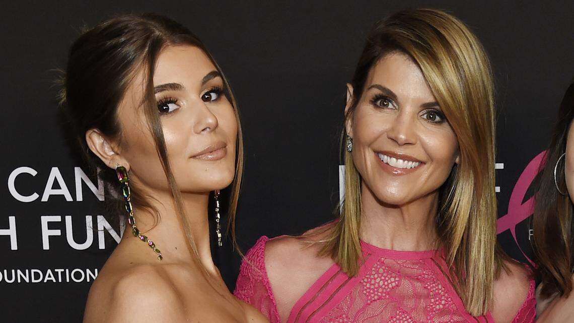 FILE - In this Feb. 28, 2019 file photo, actress Lori Loughlin poses with her daughter Olivia Jade Giannulli, left, at the 2019 “An Unforgettable Evening” in Beverly Hills, Calif. Felicity Huffman and Loughlin have worked steadily as respected actresses and remained recognizable if not-quite-A-list names for decades. Neither has ever had a whiff of criminality or scandal tied to their name until both were charged with fraud and conspiracy Tuesday along with dozens of others in a scheme that according to federal prosecutors saw wealthy parents pay bribes to get their children into some of the nation’s top colleges. (Photo by Chris Pizzello/Invision/AP, File)