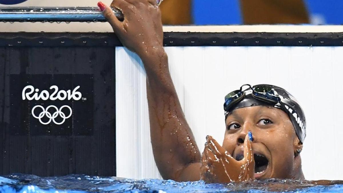 U.S. swimmer Simone Manuel reacts after seeing her first-place finish on the scoreboard at the Rio Olympics.