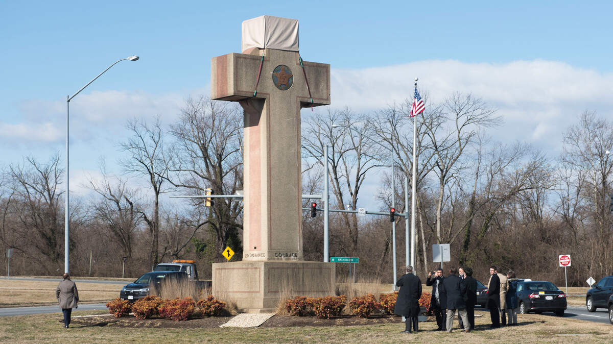 Visitors walk around the 40-foot Maryland Peace Cross dedicated to World War I soldiers on Wednesday, Feb. 13, 2019 in Bladensburg, Md. (AP Photo/Kevin Wolf)