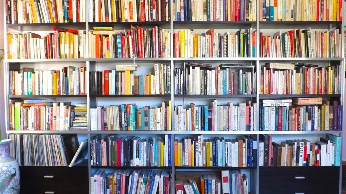 Cookbooks pack the floor-to-ceiling shelves across Elaine Corn’s living room, with one shelf devoted to Chinese books and another holding books signed by the authors.
