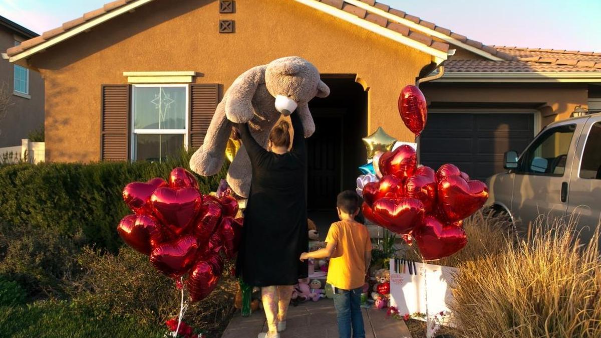 Neighbor Liza Tozier, and her son, Avery Sanchez, 6, drop off his large “Teddy” as a gift for the children of Perris homeschoolers David and Louise Turpin, who have been charged with torturing and abusing the 13 siblings for years. (AP Photo/Damian Dovarganes)