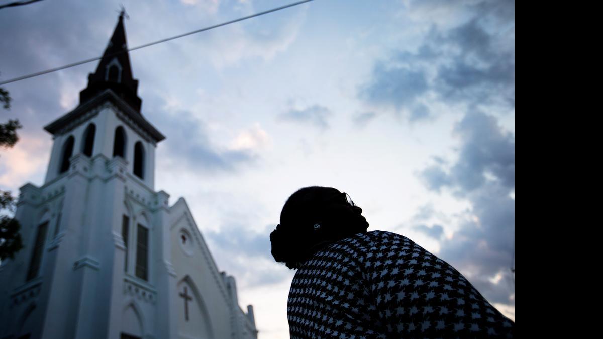 
Doris Simmons, of Charleston, S.C., stands next to Emanuel AME Church before the funeral of state Sen. Clementa Pinckney, who died in the mass shooting at the church.
