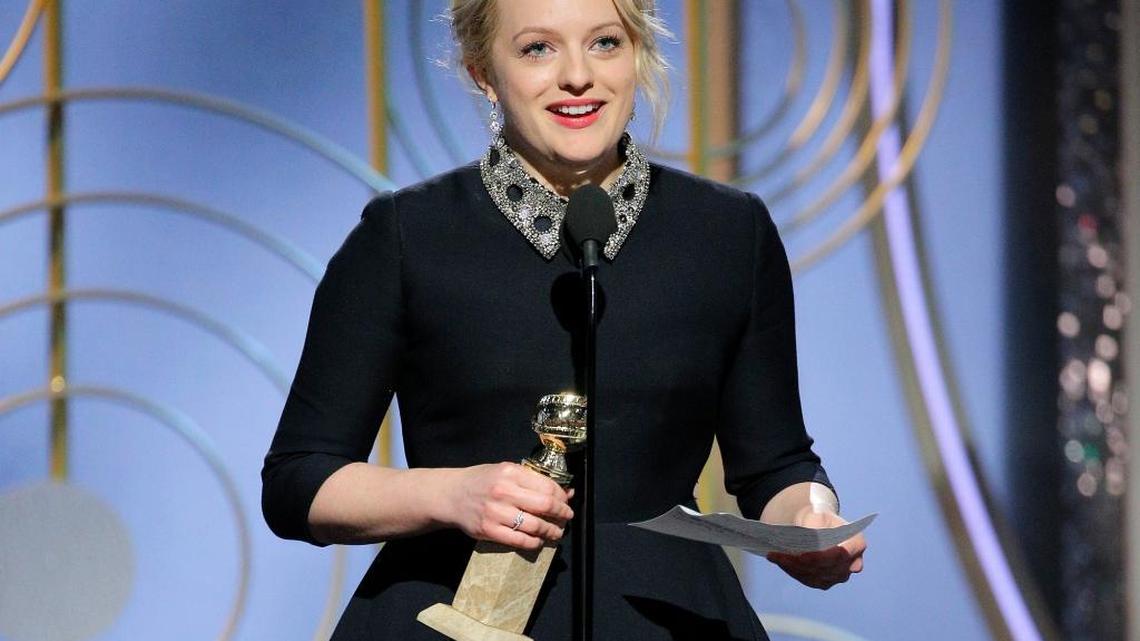 Elizabeth Moss accepts the award for best actress in a drama series for her role in “The Handmaid’s Tale,” at the 75th Annual Golden Globe Awards in Beverly Hills, Calif., on Sunday, Jan. 7, 2018. (Paul Drinkwater/NBC via AP)
