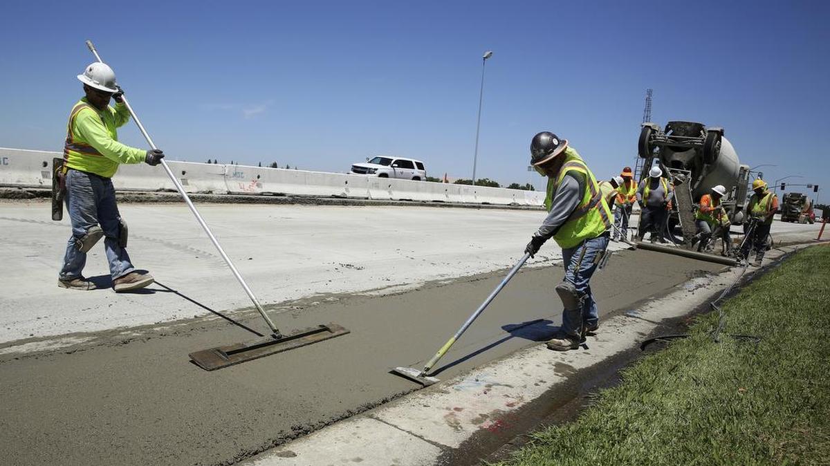 Workers repave a street in Roseville last month, partially funded by a gas tax hike passed by the Legislature in 2017. Proposition 6 on the November ballot would repeal the 2017 gas tax and vehicle fee increases to repair aging roads.