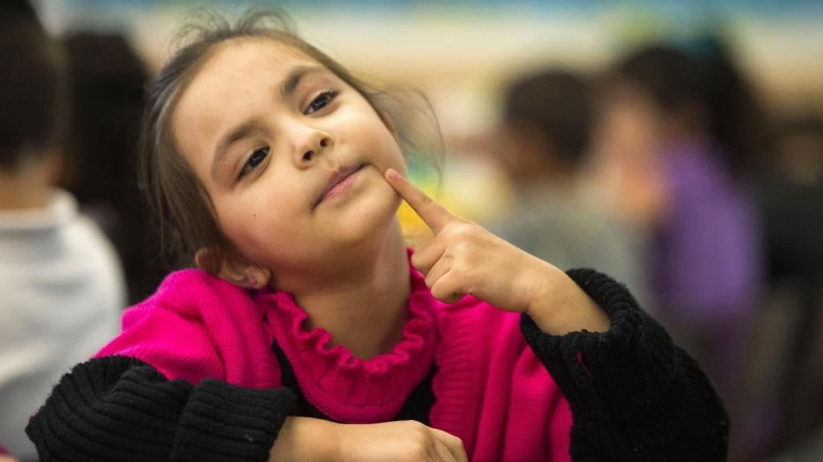 Parizad Alamzai, 6, thinks about the answer to the sound of a letter in the alphabet as she gets help from bilingual instructional aide, Dalya Abdullah at Howe Ave. Elementary School on Wednesday, January 11, 2017. The number of English learners has soared with the influx of refugee families in Sacramento County in recent years.