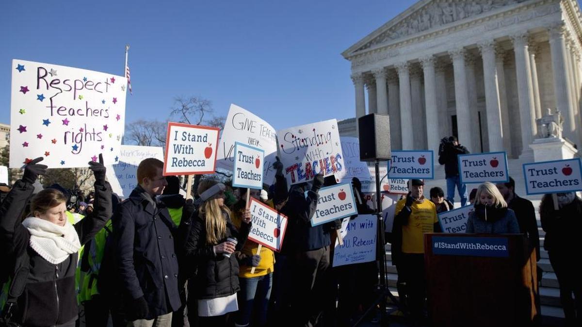 Demonstrators rally outside the U.S. Supreme Court in Washington, Monday, Jan. 11, 2016, during arguments in ‘Friedrichs v. California Teachers Association’, which previewed ‘Janus v. AFSCME,’ the upcoming 2018 Supreme Court attack on public employee union rights. (AP Photo/Jacquelyn Martin)