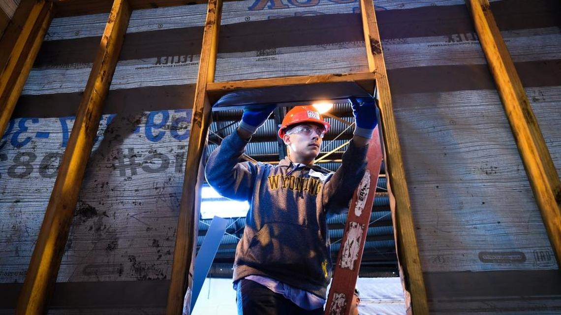 Mendota High’s Riley Lopez uses a level as he and other students learn how to attach sheet metal to a structure, during a job-shadowing day at Four C’s Construction, coordinated by the Fresno County Office of Education’s Career Technical Education program, Thursday morning, Jan. 19, 2017.